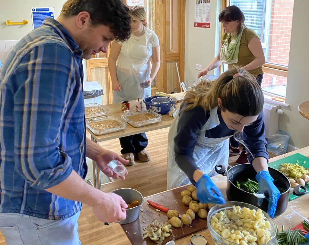 Berkeley employees prepare a meal for older people in the community.