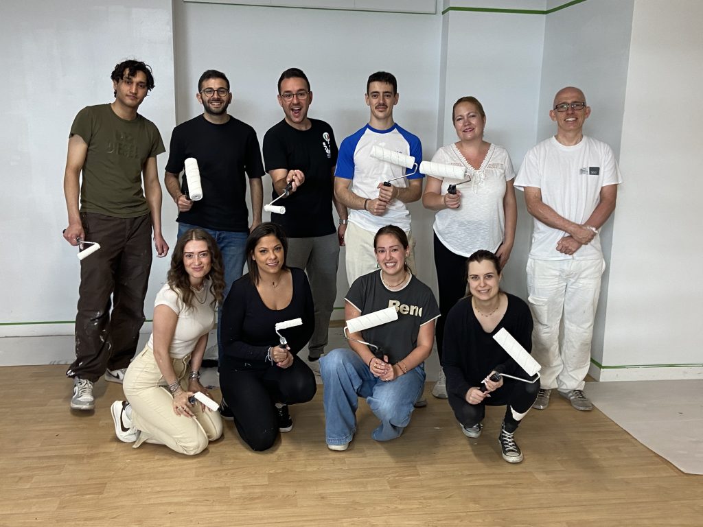 Classroom makeover: The volunteer team celebrate completing the painting task.